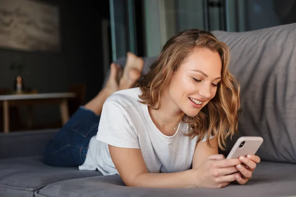 Image Happy Blonde Woman Basic Shirt Smiling Using Cellphone While — Stock Photo, Image