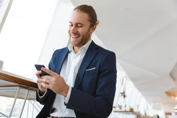 Image Handsome Cheerful Positive Young Businessman Indoors Office Using Mobile — Stock Photo, Image