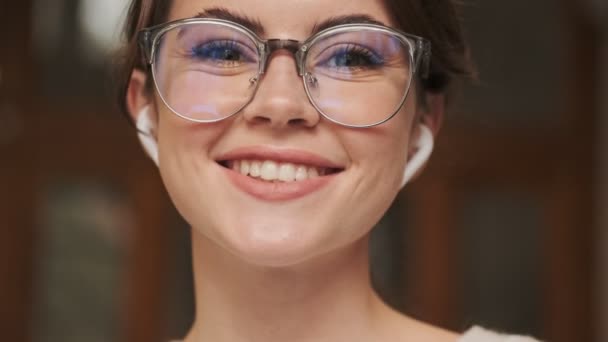 Close View Beautiful Young Girl Wearing Glasses Earphones Camera While — Stock Video