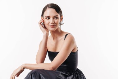 Çekici, genç, çekici, mutlu bir kadının beyaz arka planda izole edilmiş bir şekilde gülümseyişi.