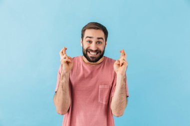 Mavi duvar arkasında izole edilmiş yakışıklı, heyecanlı, pozitif bir adamın görüntüsü umut verici bir jest olur..