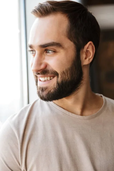 Handsome Smiling Young Bearded Man Standing Window Home Looking Away — Stock Photo, Image