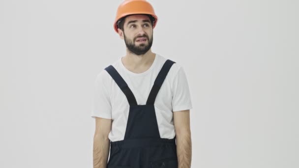 Confused Young Bearded Man Builder Isolated White Wall Background Helmet — Stock Video