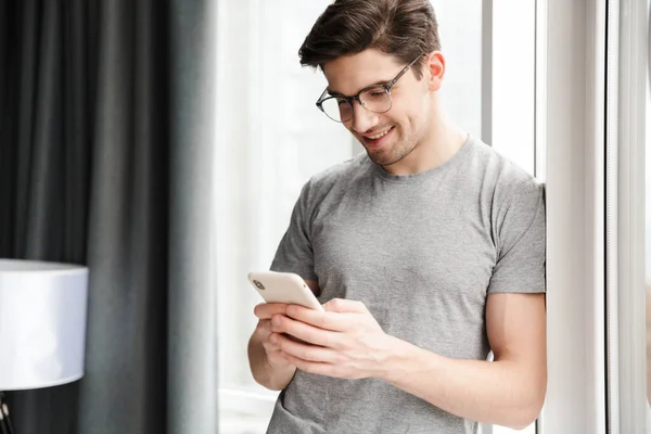 Smiling Young Attractive Man Wearing Casual Clothes Using Mobile Phone — Stock Photo, Image