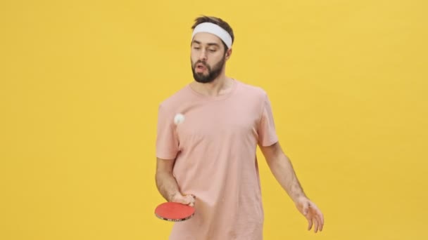 Focused Young Athletic Man Sportswear Playing Ping Pong Isolated Yellow — Stock Video