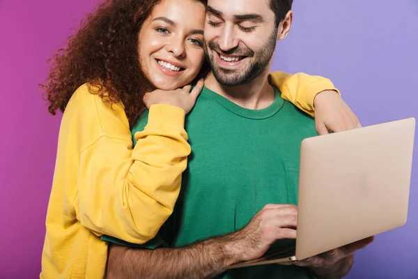 색깔의 웃으며 컴퓨터를 사용하여 보라색 떨어져 아름다운 캅카스 남녀의 — 스톡 사진