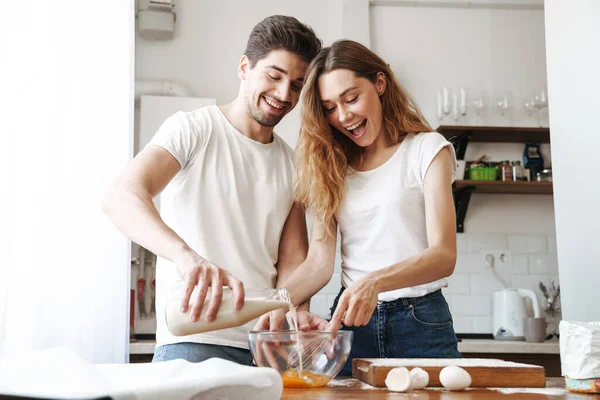Image Positive Young Couple Rejoicing While Cooking Breakfast Together Milk — Stock Photo, Image