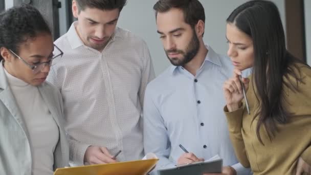 Young Concentrated Colleagues Talking Each Other Office Holding Documents — Stock Video