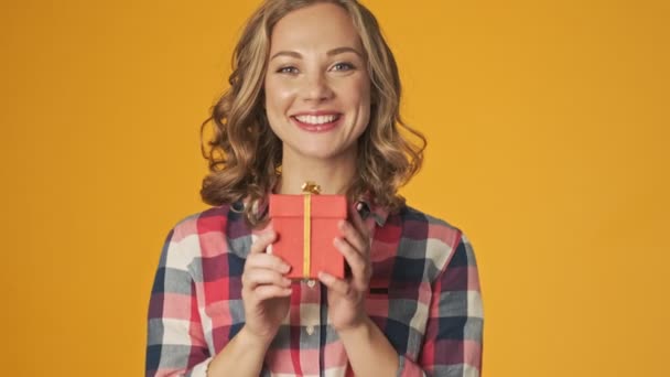 Young Happy Positive Girl Isolated Yellow Wall Background Holding Present — Stock Video