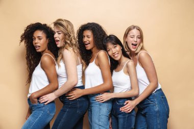 Çok uluslu güzel bir kadının bej arka planda göz kırpan ve kucaklaşan görüntüsü