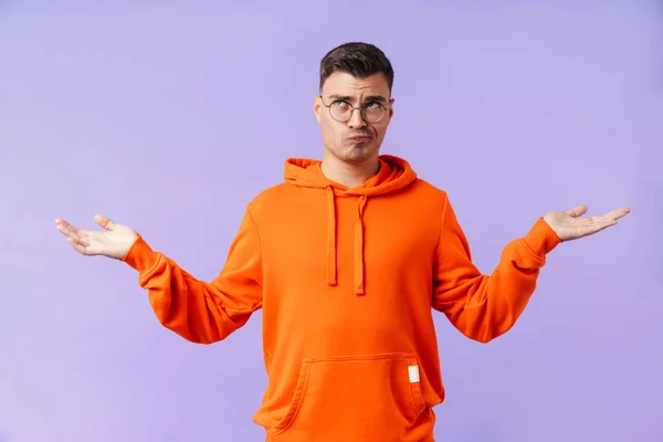 Image Confused Displeased Young Man Isolated Purple Background Wearing Eyeglasses — Stock Photo, Image