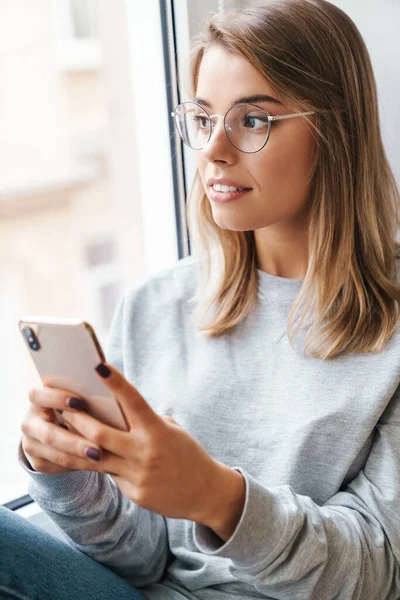 Foto Van Ernstige Mooie Vrouw Bril Met Behulp Van Smartphone — Stockfoto