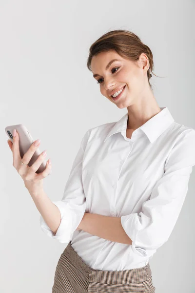 Image Pleased Beautiful Woman Smiling Typing Mobile Phone Isolated White — Stock Photo, Image