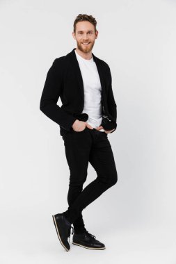 Beyaz arka planda izole edilmiş, gülümseyen ve poz veren, traşsız, memnun bir adamın görüntüsü.