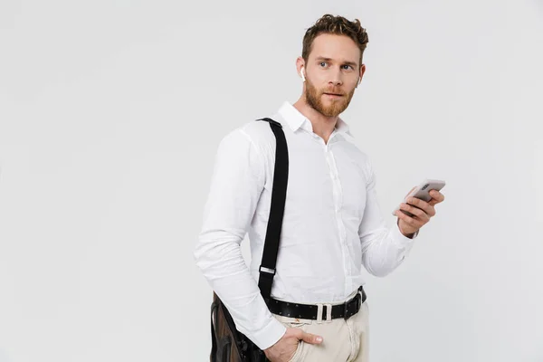 Image Pleased Blonde Man Using Cellphone Wireless Earphones Isolated White — Stock Photo, Image