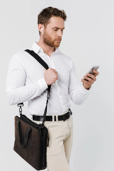 Image Focused Blonde Man Using Cellphone Wireless Earphones Isolated White — Stock Photo, Image