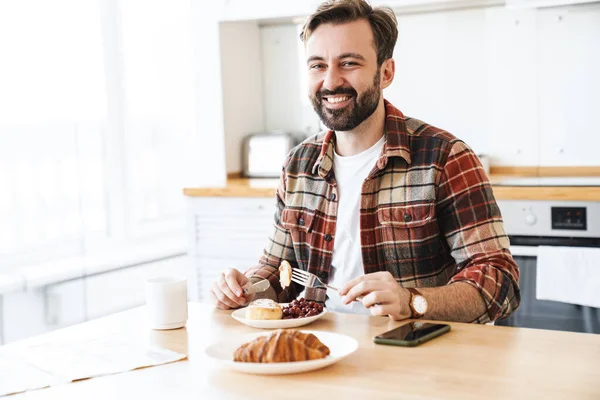 Porträtt Glad Skäggig Man Ler Och Äter Tårta Medan Äter — Stockfoto