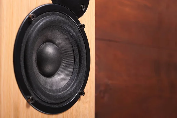 Wooden speaker on the brown wooden background — Free Stock Photo
