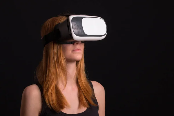 Studio portrait of young girl playing with virtual reality — Stock Photo, Image