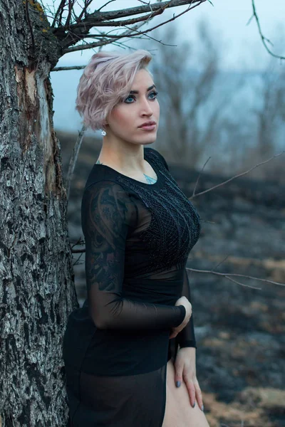 Retrato ao ar livre de uma jovem em um estilo escuro — Fotografia de Stock