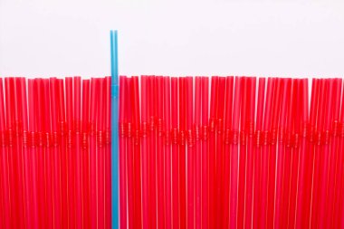 One blue cocktail tube among the line of red tubules