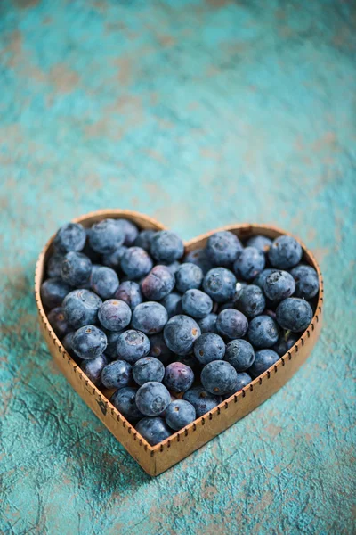 Blueberries in heart shape symbol — Stock Photo, Image