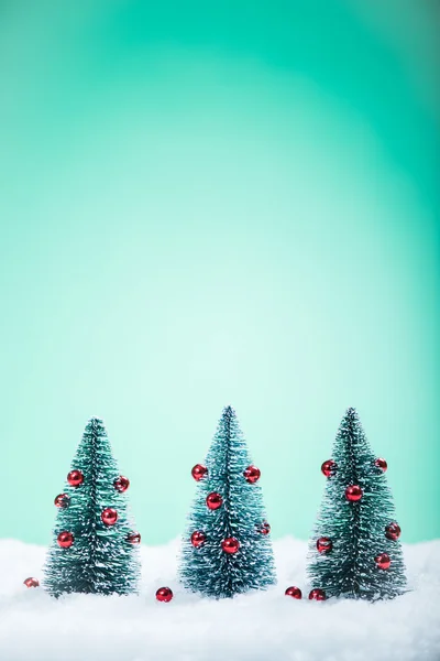 Christmas trees with decoration in snow — Stock Photo, Image