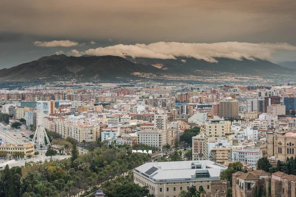 Rolling clouds over Malaga cityscape