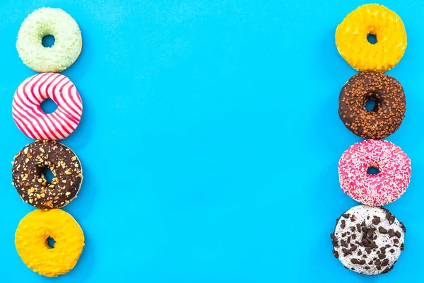 Donuts colorido borde de fondo, vista superior plana laico — Foto de Stock