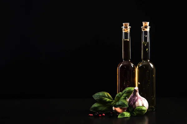 Olive oils in bottles with herbs and spices — Stock Photo, Image