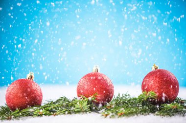 Noel kırmızı topları ve kar üzerinde yeşil çam