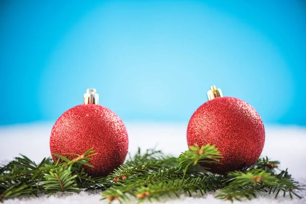 Christmas red balls and green fir on snow — Stock Photo, Image