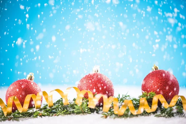 Christmas ornaments on snow background — Stock Photo, Image