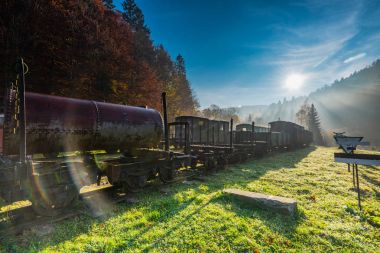 Sun rays and flare at misty morning in abandoned railway station clipart