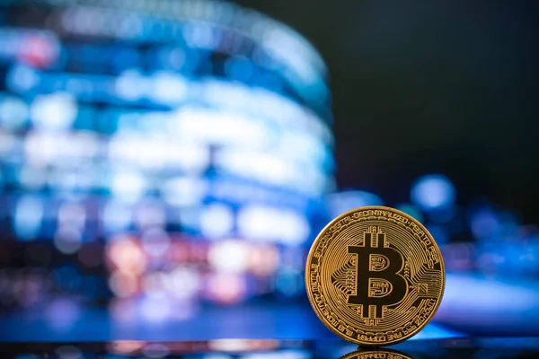 Bitcoin against moder business centre blurred — Stock Photo, Image