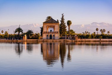 Saadian pavilion,Menara gardens and Atlas in Marrakech, Morocco, clipart