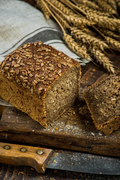 Wholegrain bread with seeds sliced on board