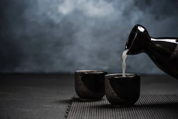 Nalewania sake do popijając miski ceramiczne — Zdjęcie stockowe