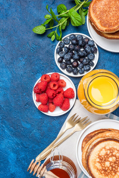 Fresh Healthy Pancakes with Fruits Toppings and Honey. Top Down View.