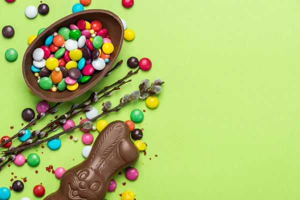 Easter Background. Festive Chocolate Egg and Rabbit. Colorful Ester Sweet Food. Copy SPace, Top View.