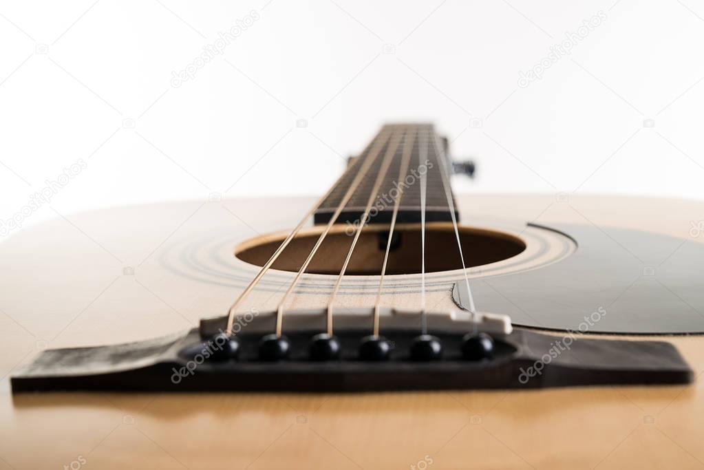 Acoustic guitar lies in a frame on a white isolated background. Horizontal frame