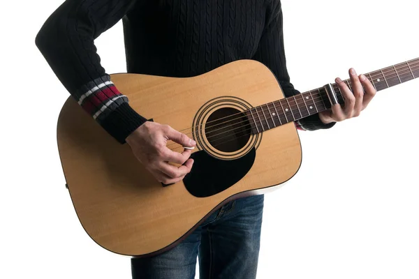 A guitarist in jeans and a black sweater, plays an acoustic guitar with a slider, in the center of the frame, on a white background. Horizontal frame. — Stock Photo, Image