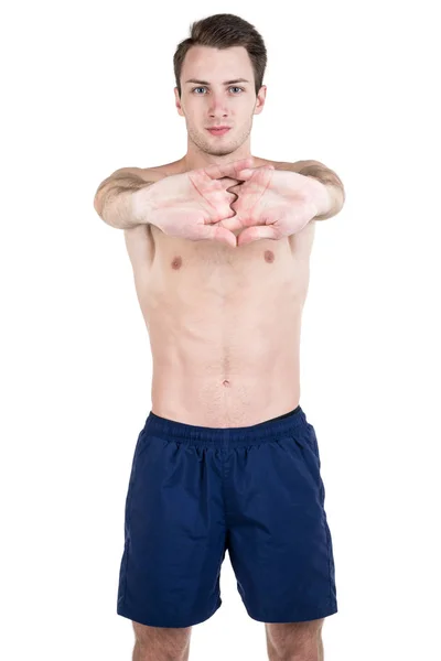 Healthy lifestyle. Portrait of a handsome guy with a sporty naked body, warming up, isolated on white background. Vertical frame — Stock Photo, Image