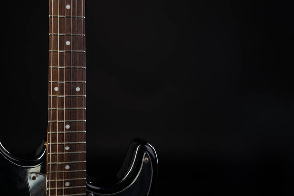 Music and art. Electric guitar on a black isolated background