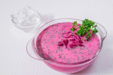 Pancar ve beyaz bir tabak içinde otlar ile pembe çorba lezzetli, iştah açıcı. Yatay Çerçeve