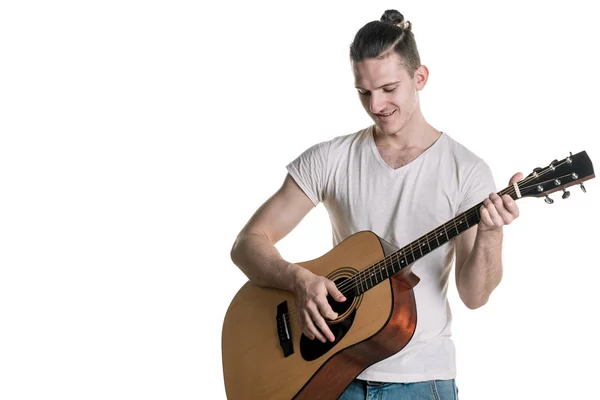 Music and creativity. Handsome young man in t-shirt playing on acoustic guitar. Horizontal frame — Stock Photo, Image