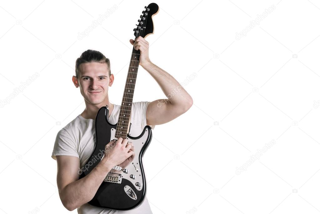 Music and creativity. Handsome young man in a T-shirt playing an electric guitar. Horizontal frame