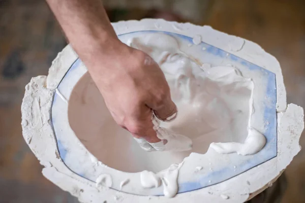 Las manos del escultor llenan el líquido blanco en el molde. Marco horizontal — Foto de Stock