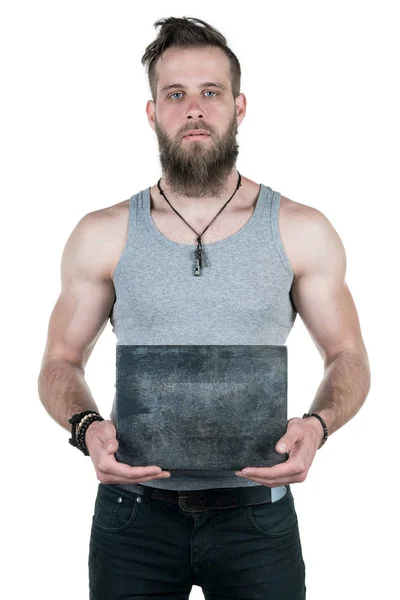 A charismatic man with a beard holds an empty gray plate for a copy space on a white isolated background. Vertical frame — Stock Photo, Image