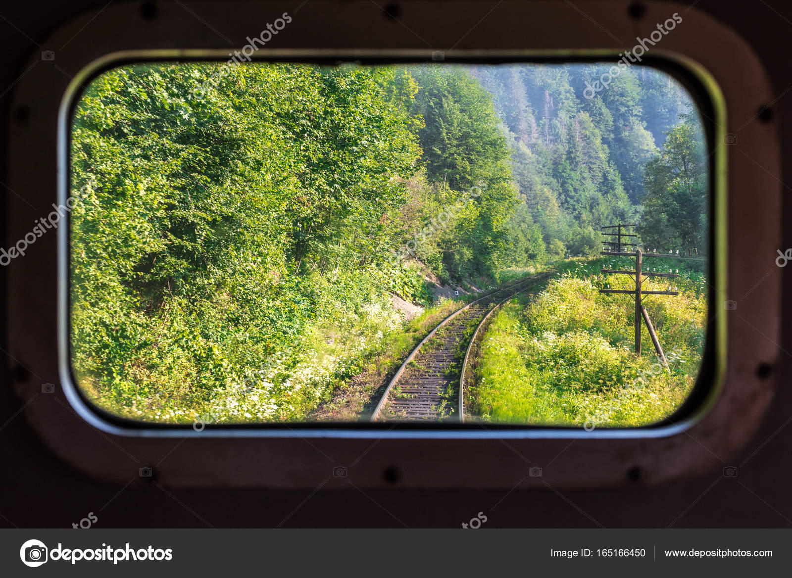 A View Of The Railway Tracks Through Train Window